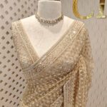 Net saree with diamond like jaal design and beaded zigzag pattern on border