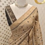 Semi tussar with check pattern and small triangle shapes on border