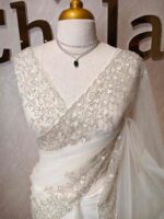 Net saree with intricate floral embroidery along the border