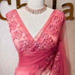Net saree with intricate floral and vine embroidery along the border