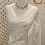 Organza with small floral, leafy applique work and diamond shaped thread work border