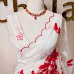 Crushed organza with dark colour floral applique work and all-over small buttas