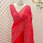 Organza with vertical metallic looking thread and decorative scallop boarder