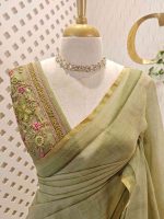 Linen saree with a border is adorned with detailed floral embroidery, possibly using French knots, and features sequins and a decorative woven edge - Image 5