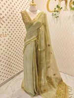 Linen saree with a border is adorned with detailed floral embroidery, possibly using French knots, and features sequins and a decorative woven edge - Image 6