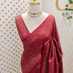 Soft katan with the main body of the saree has an all over floral motif and the boarder has diamond shaped patterns