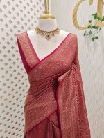 Soft katan with body features floral pattern enclosed within geometric diamond shapes. and a decorative zari border with repetitive linear and floral elements