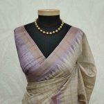 Jute silk saree with lines on the body portion and with contrast side boarder