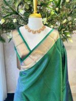 Kanjeevaram saree with a check pattern across the main body and complemented by a rich border and pallu