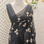 Net kota saree with thread work embroidery in a repeating pattern of leaves and small berry-like clusters on a vine