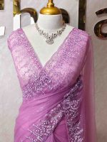 Net saree with a combination of floral sequin motifs and delicate beadwork, often with a decorative scalloped border