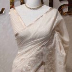 Tissue saree with delicate embroidery work with a wine pattern along with scalloped boarder