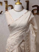 Tissue saree with delicate embroidery work with a wine pattern along with scalloped boarder