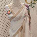 Kerala saree with thick large contrast flowers and  on the pallu and prints on body