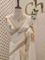 Kerala saree with large lily-like flowers with delicate green stems and leaves.