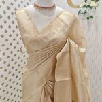 Kerala saree with rose like motif decorated with shining thread on the pallu and body
