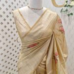 Kerala saree with sequins are scattered throughout the floral pattern