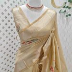 Kerala saree with floral motifs and the outline is decorated with shining thread and sequins