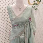 Tissue saree with contrast bundle like floral motifs and small leafs along with sequins and cut beads