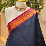 Kanjee cotton with small buttas on the body and contrast zari border with floral geometric woven detailing