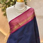 Kanjee cotton with minimal buttas allover the body and contrast peacock motif woven border