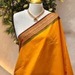 Kanjee cotton with small buttas allover the body and contrast traditional zari woven border with peacock motif