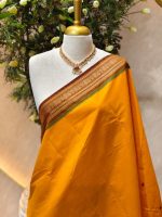 Kanjee cotton with small buttas allover the body and contrast traditional zari woven border with peacock motif