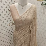 Net saree with Dense sequins, bead embroidery and floral like vine motifs