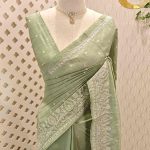 Semi tussar with paisley and floral embroidery along the border and embroidered buttas across the body
