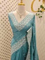 Semi tussar with minimal floral buttas allover the body and heavy embroidered border