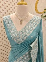 Semi tussar with minimal floral buttas allover the body and heavy embroidered border - Image 2