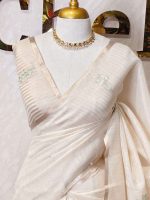 Tissue silk with thick floral applique embroidery on the pallu and minimal floral motifs allover the body. - Image 2