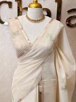 Tissue silk with thick floral applique embroidery on the pallu and minimal floral motifs allover the body. - Image 10