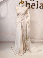 Tissue silk with thick floral applique embroidery on the pallu and minimal floral motifs allover the body. - Image 3