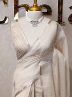 Tissue silk with thick floral applique embroidery on the pallu and minimal floral motifs allover the body. - Image 4