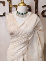 Tissue silk with thick floral applique embroidery on the pallu and minimal floral motifs allover the body. - Image 7