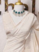 Tissue silk with thick floral applique embroidery on the pallu and minimal floral motifs allover the body. - Image 8