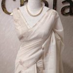 Tissue silk with floral vien like applique-embroidery on the pallu and minimal floral motifs allover the body.