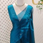 Tissue silk saree with changant colour complemented by kuchu tassel detailing
