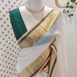 Mul cotton saree with a plain body,complemented by a broad zari border with contrast edging and tassel detailing