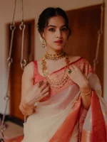 Organza banarasi with leafy-inspired zari-woven buttas all over the body and a rich traditional contrast border