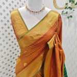 Soft silk with a zari checkered body, traditional zari buttas, and a contrast geometric zari-woven border