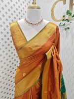 Soft silk with a zari checkered body, traditional zari buttas, and a contrast geometric zari-woven border