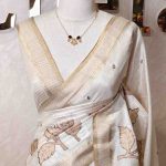 Semi Tussar with oversized floral applique-embroidery on the lower body and minimal floral buttas all-over the body