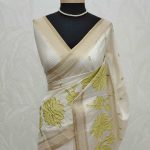 Semi Tussar with oversized floral applique embroidery on the body complimented by minimal floral buttas across the body