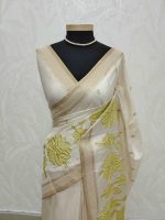 Semi Tussar with oversized floral applique embroidery on the body complimented by minimal floral buttas across the body