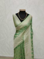 Tissue Banarasi with leafy-inspired zari-woven buttas all over the body, complemented by a rich self zari-woven border