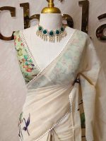 Tissue saree with orchid -inspired floral applique-embroidery on the lower body complimented by a lace-detailing  border