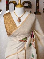 Tissue saree with oversized lotus-inspired floral prints gracefully spread across the body