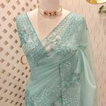 Organza saree with sequins established floral embroidery and scalloped border